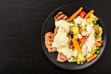 Grilled pork tenderloin and boiled vegetables with cream mustard sauce.