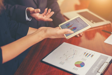 Graphs and charts being demonstrated on the screen of a touch-pa