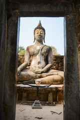 Fototapeta na wymiar Old buddha in the temple at Sukhothai Historical Park in Sukhothai Province, Thailand
