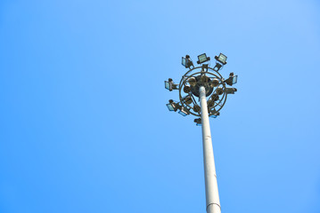 Fototapeta na wymiar Pillar spotlights high on clear blue sky. Copy space.