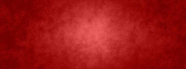 Red background in Christmas or valentines day red color with vintage texture and shiny center spot