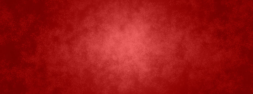 Red background in Christmas or valentines day red color with vintage texture and shiny center spot