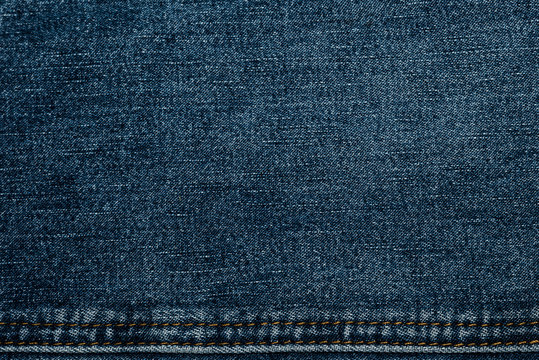 Texture of jeans fabric in high resolution with a suture thread yellow