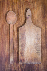 wooden cutting board and spoon on a wooden background

