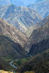 Obraz premium View of rocky gorge with steep slopes and wild river