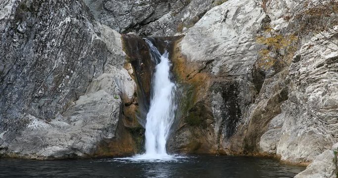 Pretty waterfall over rocks. 4K movie.