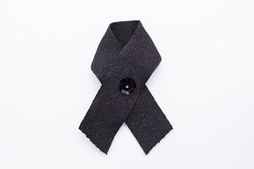 Black awareness ribbon on white background. Mourning and melanom