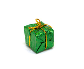 Big green gift on white background. Christmas gift box in foliage wrapping with gold thread bow.
