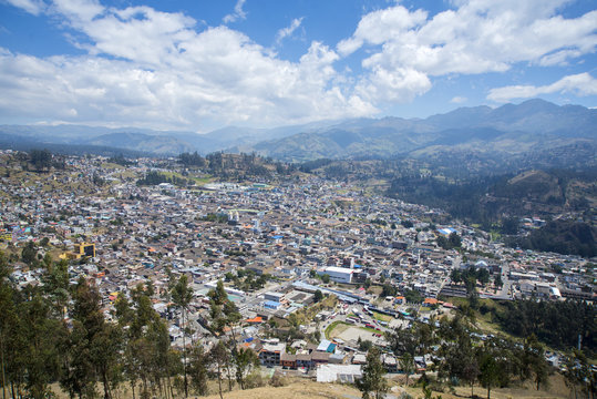 High view of the town of Guaranda, surrounded by the Andes mountains, on a sunny day. Ecuador