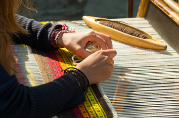 Crafts. Hand weaving loom with many colorful woolen threads.