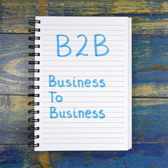 B2B- Business To Business text written in notebook on wooden background