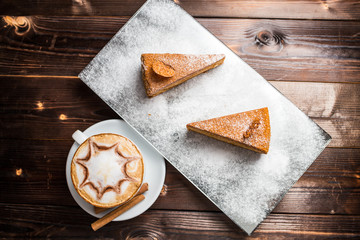 honey cake on a brown table with cup of coffe