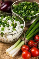 Homemade Herb Curd in bowl (close-up shot) on vintage wooden bac