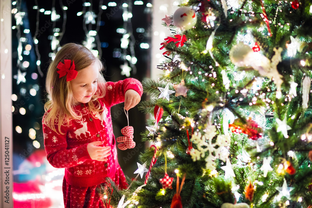 Wall mural child decorating christmas tree