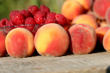 good juicy ripe fruits plate raspberries and peaches.