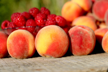 good juicy ripe fruits plate raspberries and peaches.