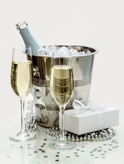 Two champagne glasses, cooler