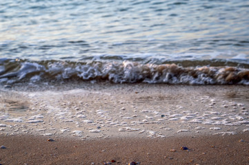 Sandy beach and wave on the sea coast