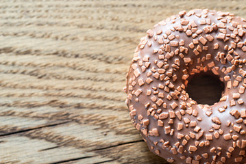 Chocolate donut on the wooden background
