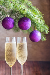 Two glasses of champagne with Christmas tree branch