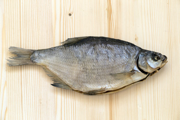 dried bream on a light wooden board..