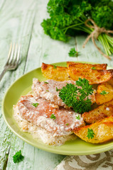 Pork chops with sour cream and baked potatoes