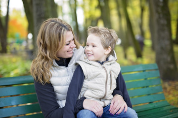 Fototapeta na wymiar Mother with the child in autumn season