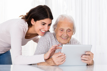 Two Happy Women Using Digital Tablet