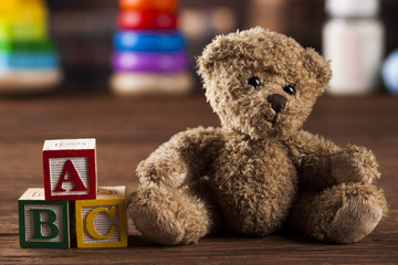 Teddy bear on on vintage wooden background