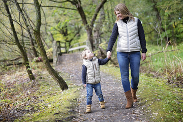 Fototapeta premium Adorable little boy with his mother in autumn park