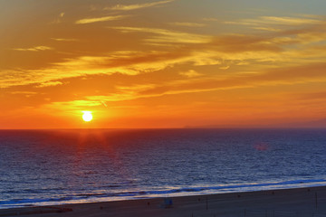 The Pacific Ocean is during sunset. Landscape with blue sea, the mountains and the dusk sky, the USA, Santa Monica. 