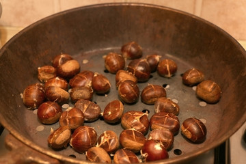 Chestnuts roasting in a pan. Selective focus.

