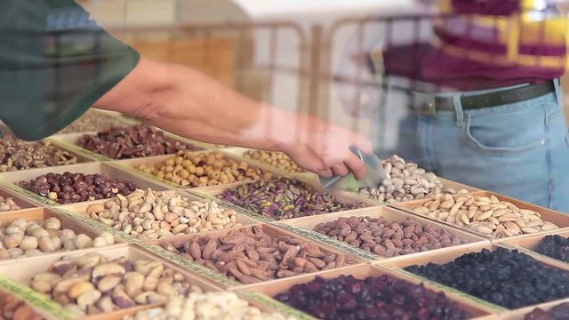 Shop with different nuts, customer selects the type of nuts