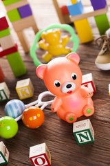 Stuffed baby toys on wooden background