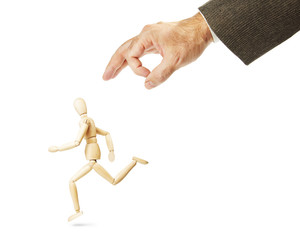 Man runs away from hitting. Abstract image with a wooden puppet