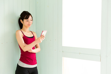 young asian woman using smart phone in the room