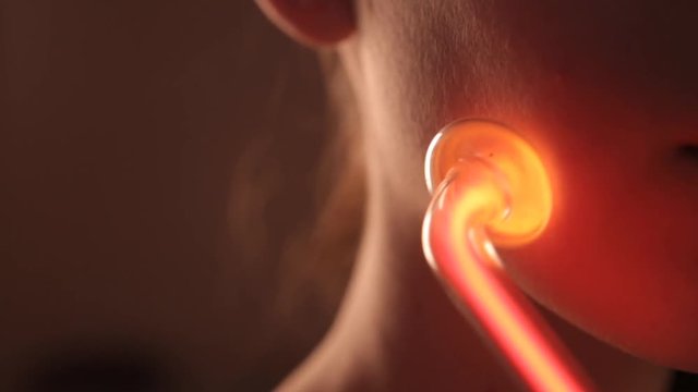 Close up of darsonvalization face of a girl with clay mask in beauty saloon