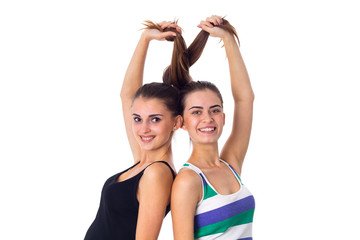 Fototapeta na wymiar Two young women holding their hair