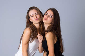 Two young women sending kisses