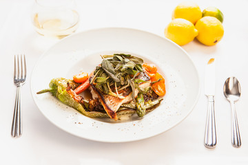 grilled seabass with sage, asparagus, tamatoes, carrots and chiles and a glass of chardonnay