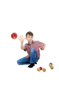 Boy throwing a Christmas tree ball. Isolated on white background.