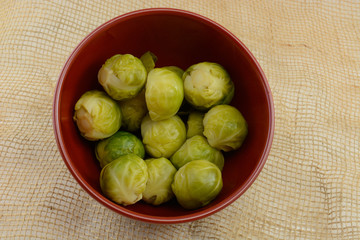 Cooked brussel sprouts in red bowl