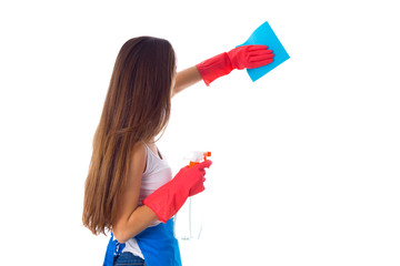 Woman using duster and detergent 