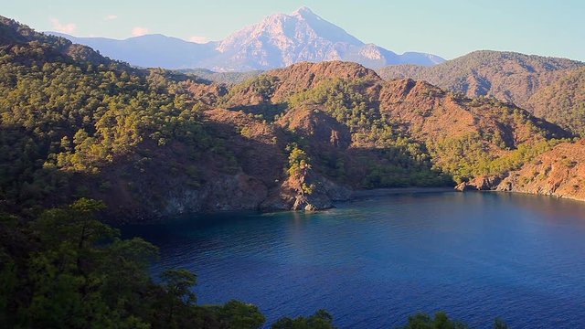 Top view of the seacoast of bay Cirali with green trees and Tahtali Dag, Turkey