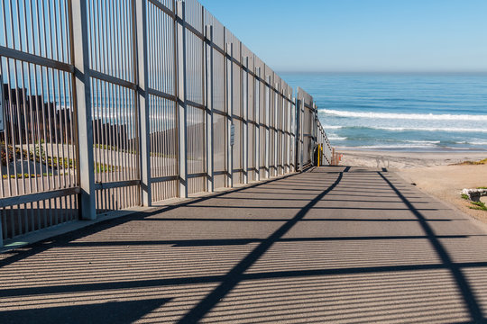 Inner fence of the international border wall which extends out into the Pacific ocean and separating San Diego, California from Tijuana, Mexico.