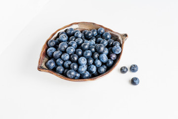 Blueberry in bowl on white