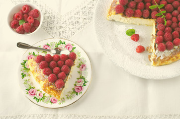 Cheesecake, souffle, cream mousse, pudding dessert with fresh raspberries and mint leaves on a white plate