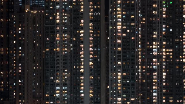 Timelapse shot of windows lights in high-rise apartment block in night Hong Kong