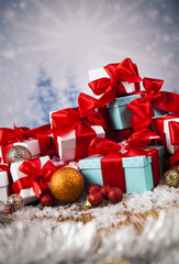 Beautiful gift box with red ribbon on Christmas background