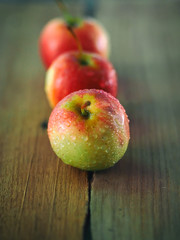 Red apple on rustic wooden table with soft focus and vintage color tone